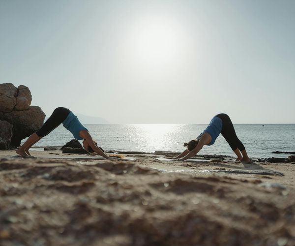 Person stretching outdoors during a beautiful sunrise.